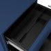 Right-facing top-down modern navy blue steel file cabinet opened to show top drawer interior compartments on white background.