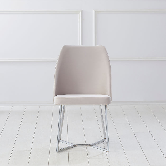 Front-facing modern glam white microfiber dining chair with a geometric base in an empty room