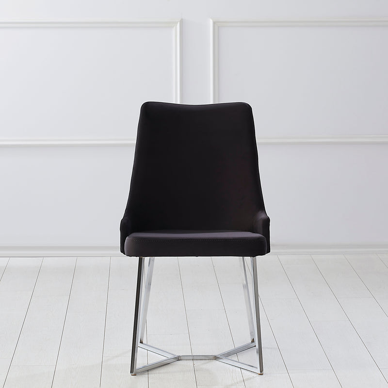 Front-facing modern glam black microfiber dining chair with a geometric base in an empty room
