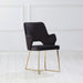 Right-angled modern glam black microfiber dining armchair with a geometric base in an empty room