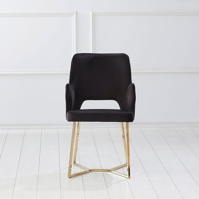 Front-facing modern glam black microfiber dining armchair with a geometric base in an empty room