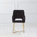 Front-facing modern glam black microfiber dining armchair with a geometric base in an empty room