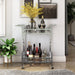 Front-facing contemporary chrome and tempered glass serving cart with quatrefoil accents in a living area with accessories