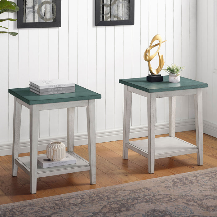Right angled contemporary two-tone wood side tables with decor in a living room. Light green plank style tabletops rest on white bases with open bottom shelves for a coastal vibe and ample storage space.