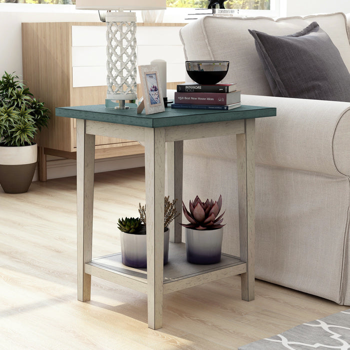 Right angled mid-century modern antique light gray and white side table with a lower shelf in a living area with accessories