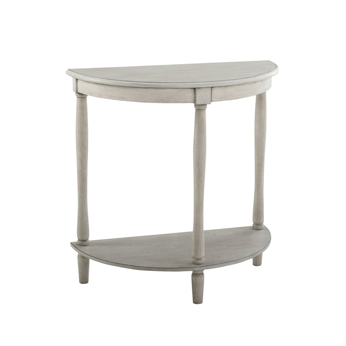 Right-angled demi-lune accent table in an antique white finish with turned legs on a white background