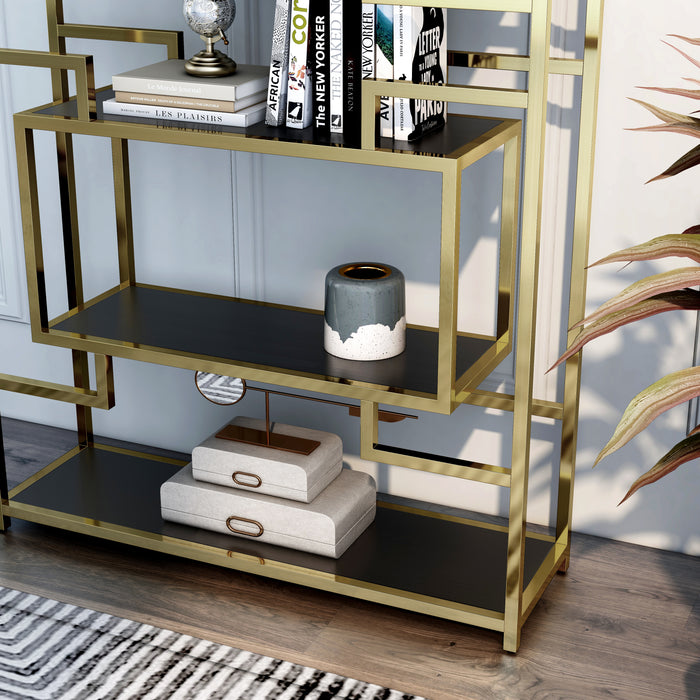 Light-angled close up modern glam geometric etagere bookcase in gold lower left shelf and geometric detail on a light gray wall with accessories