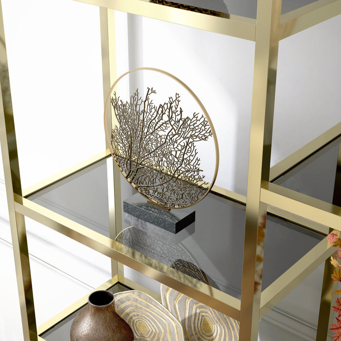 Left-angled close up modern glam staggered shelf etagere bookcase in gold with six shelves in a contemporary living space with accessories