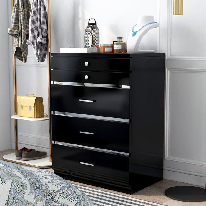 Left-angled high gloss black jewelry chest in a glam bedroom. Accessories sit on the chest while an outfit hangs on the gold rack next to it.