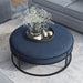 Front-facing top view contemporary navy and black round ottoman in a living room with accessories