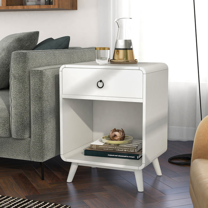 Left angled mid-century modern antique white side table with single drawer and open bottom cabinet space decorated next to a sofa in a living room.