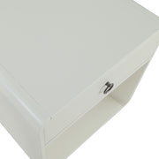 Right angled close up top corner detail of a mid-century modern one-drawer white side table on a white background