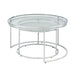 Left angled glam chrome and clear glass two-piece nesting tables, shown nested, on a white background