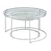 Left angled glam chrome and clear glass two-piece nesting tables, shown nested, on a white background