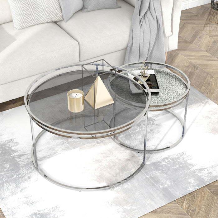 Right angled top view of glam chrome and gray glass two-piece nesting tables on a white background