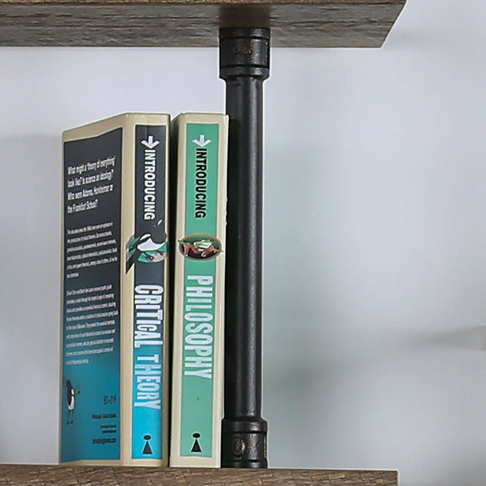 Front-facing close up industrial natural and sand black wall shelf support detail on a wall with accessories
