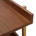 Left angled close up top rear corner shelf detail of a contemporary three-shelf light walnut and gold bookcase on a white background