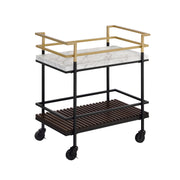 Right-angled two-tier serving cart against a white background. The clean-cut bar handles are gold and transition into a black frame. White faux marble makes up the upper shelf while a walnut-finished slatted lower shelf adds a contrasting and unexpected textured look.