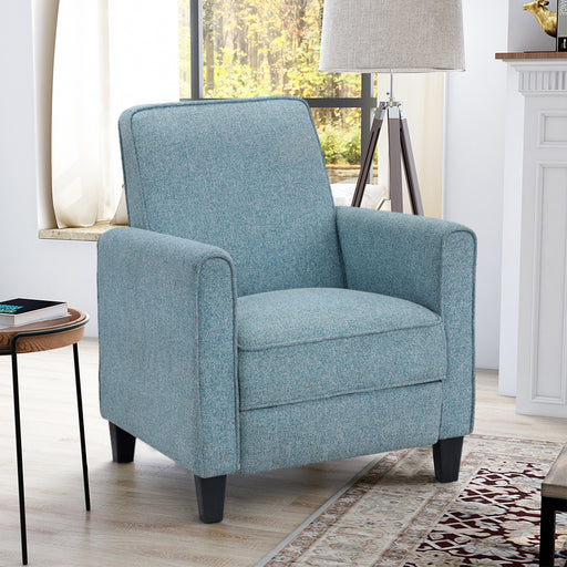 Right-angled blue upholstered armchair in a contemporary living room. A straight squared back with rounded, track arms come together in a slender silhouette with welted trim. Tapered feet complement this clean profile.