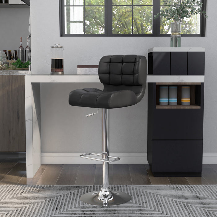 Left-angled  grey leatherette bar chair against with accessories. The biscuit tufted swivel seat is a modern look against the chrome pedestal base with footrest.