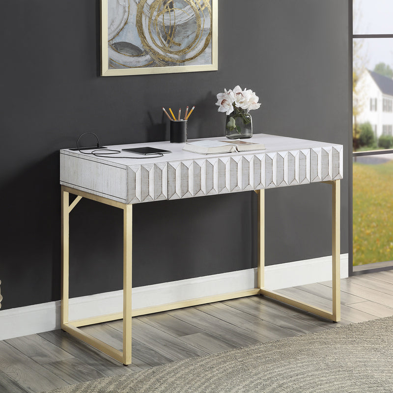 Angled right-facing view of antique white finish mid-century modern writing desk with drawer in room with accessories