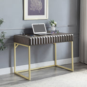 Angled right-facing view of walnut finish mid-century modern writing desk with drawer in room with accessories
