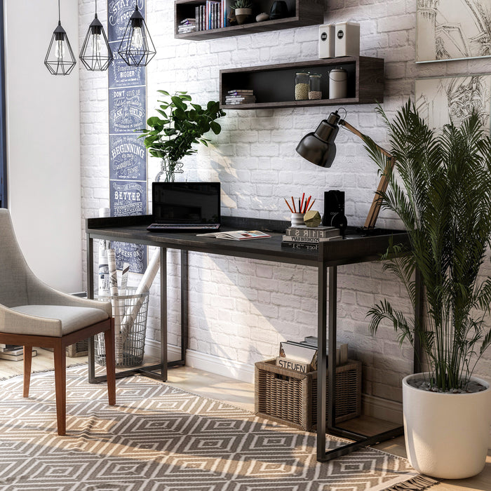 Angled left-facing view of black metal and MDF urban desk in living room with accessories