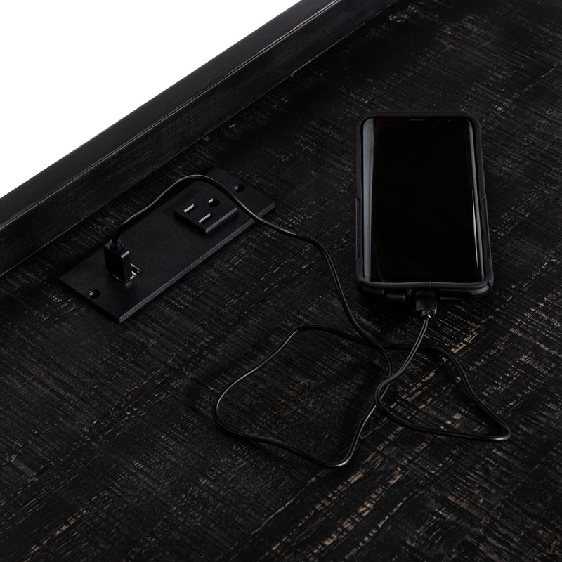 Angled incomplete top-down view of desktop section of black metal and MDF urban desk with charging outlets on white background
