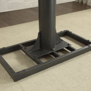 Angled and cropped right-facing view of metal base of industrial black and rustic oak steel and veneer adjustable desk in living space