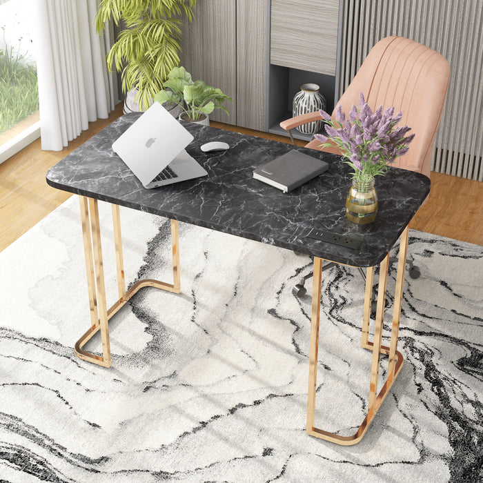 Angled right-facing view of contemporary gold steel and black marble top writing desk with accessories