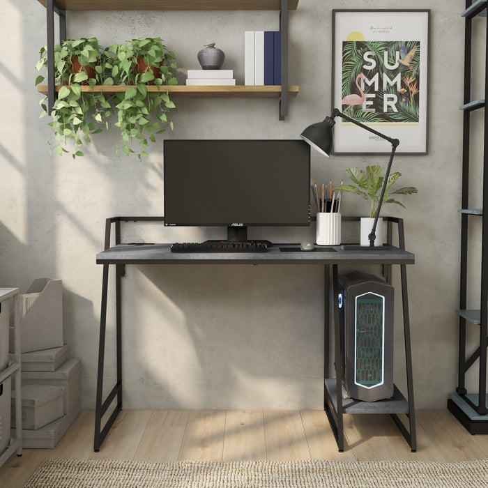 Front-facing view of urban light gray and matte black steel writing desk with accessories