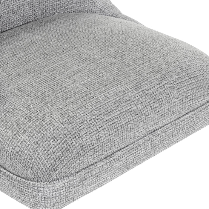 Right angled close up seat view of a light gray and chrome wingback office chair on a white background