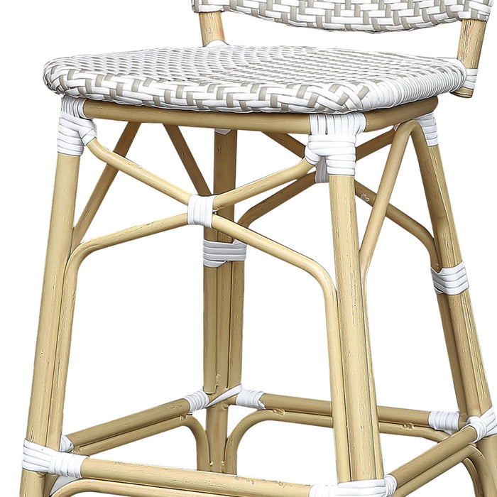 Detail shot of a grey and white chevron patterned wicker patio bar chair with a natural tone frame.