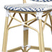 Detail shot of a navy and white chevron patterned wicker patio bar chair with a natural tone frame.
