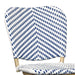 Detail shot of a navy and white chevron patterned wicker curved backrest.