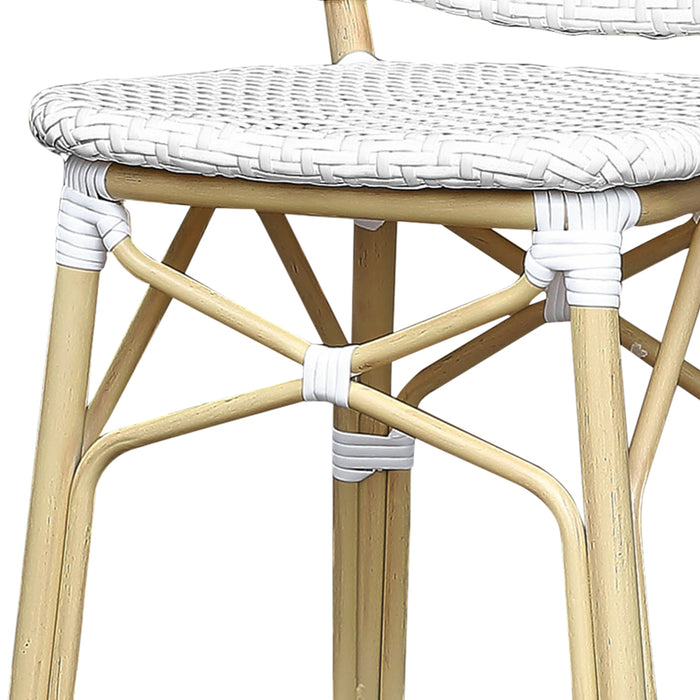 Detail shot of a white chevron patterned wicker patio bar chair with a natural tone frame.