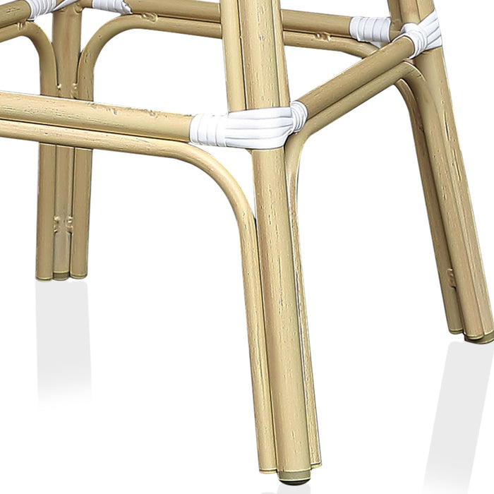 Detail shot of a natural tone patio bar chair frame with footrests.