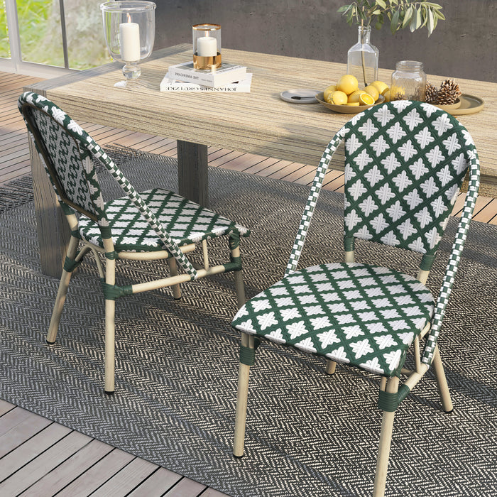 Green patterned wicker bistro chairs in a bohemian style dining space.