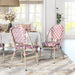 Pink patterned wicker bistro chairs in a bohemian style dining room.
