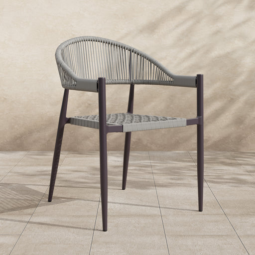 Right-angled bohemian faux wicker patio dining chair in a two-tone finish in an outdoor space