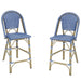 Angled set of two French style blue and white wicker counter height patio chairs on a white background