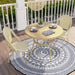 Natural tone and yellow wicker bistro set on a porch. The tabletop features a slatted design with an umbrella hole, while a chevron pattern wicker adds style to the chairs.