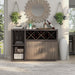Front-facing distressed taupe stemware and X-shaped wine rack cabinet in a living room with accessories