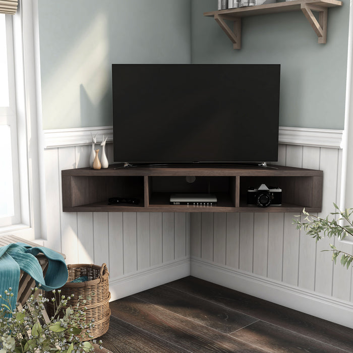 Front-facing modern walnut oak floating corner TV stand in a living area with accessories