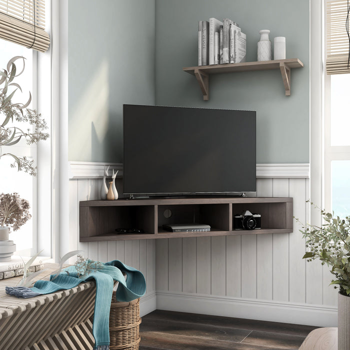 Right angled modern walnut oak floating corner TV stand in a living area with accessories