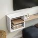 Angled view of modern white and natural finish geometric floating TV stand