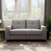 Front-facing contemporary gray upholstered loveseat with tufted back cushions and wide track arms in a contemporary living room