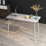 Elevated and angled view of contemporary white oak finish writing desk in living space with accessories