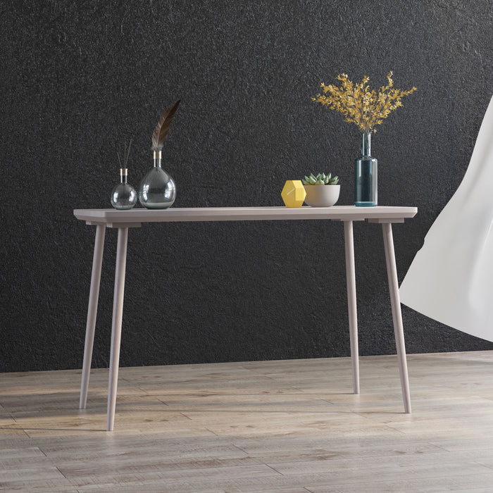 Angled view of contemporary white oak finish writing desk in living space with accessories