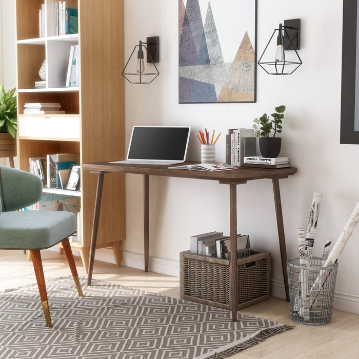 Angled right-facing view of contemporary walnut oak finish desk in living space with accessories